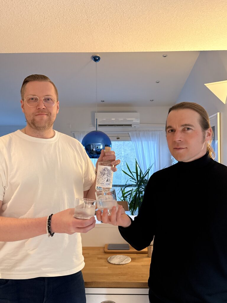 Spirit of the Cascade Imatra Dry Gin and Imatra Spirits Oy founders Taavi Kuisma and Mikko Rasimus with a bottle of Spirit of the Cascade Gin