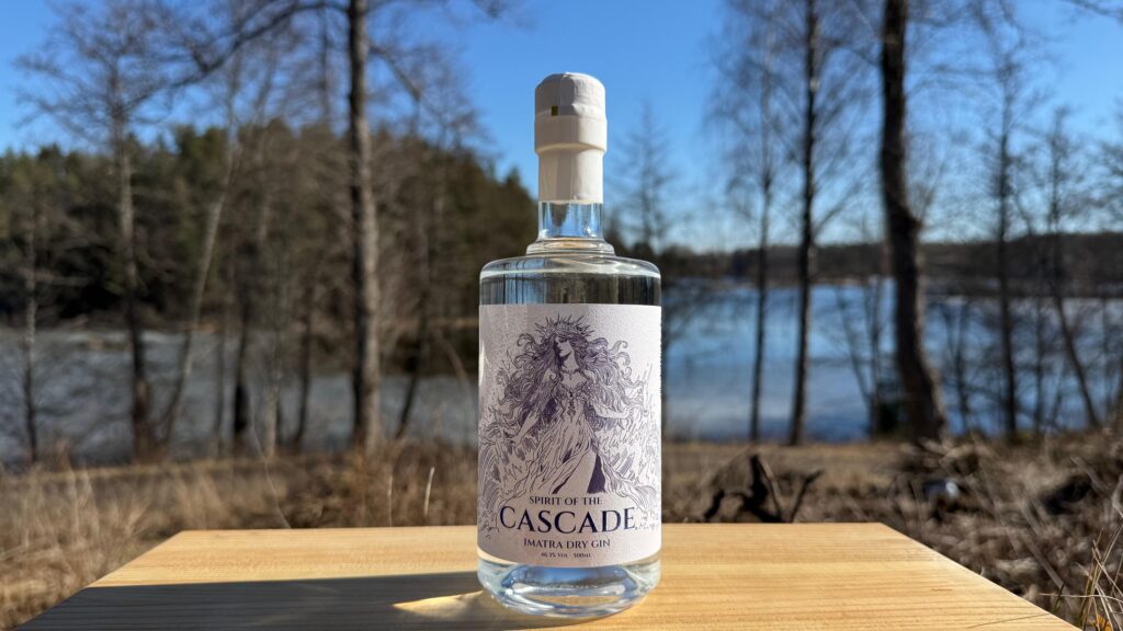 Spirit of the Cascade Imatra Dry Gin bottle at the shore of Vuoksi River and Mellonlahti